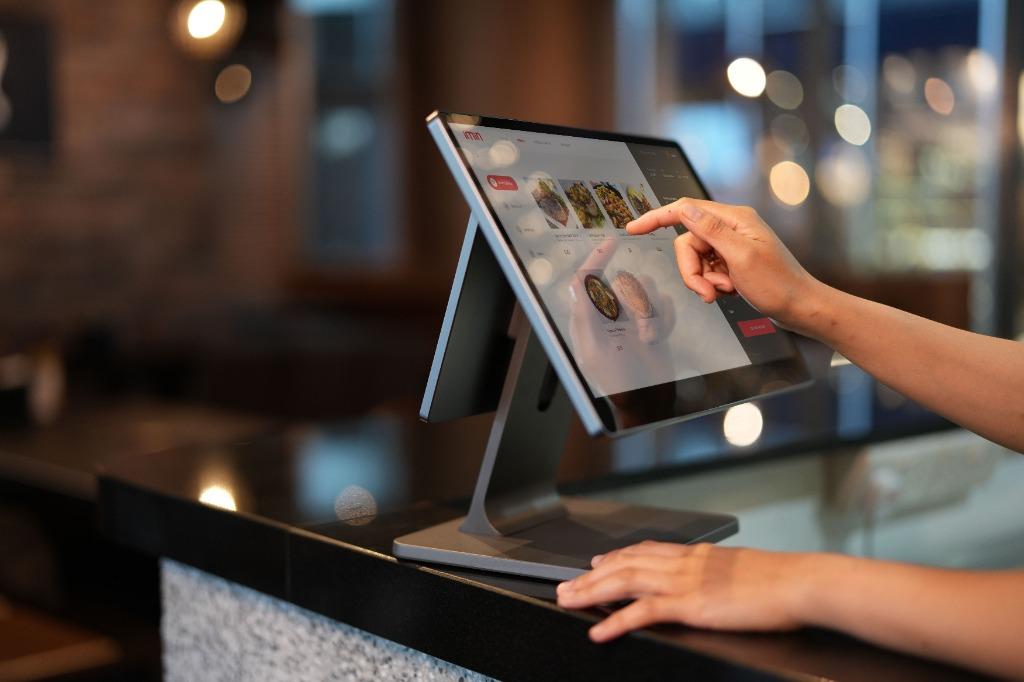 NexusBOS touchscreen dual-display POS system on retail counter